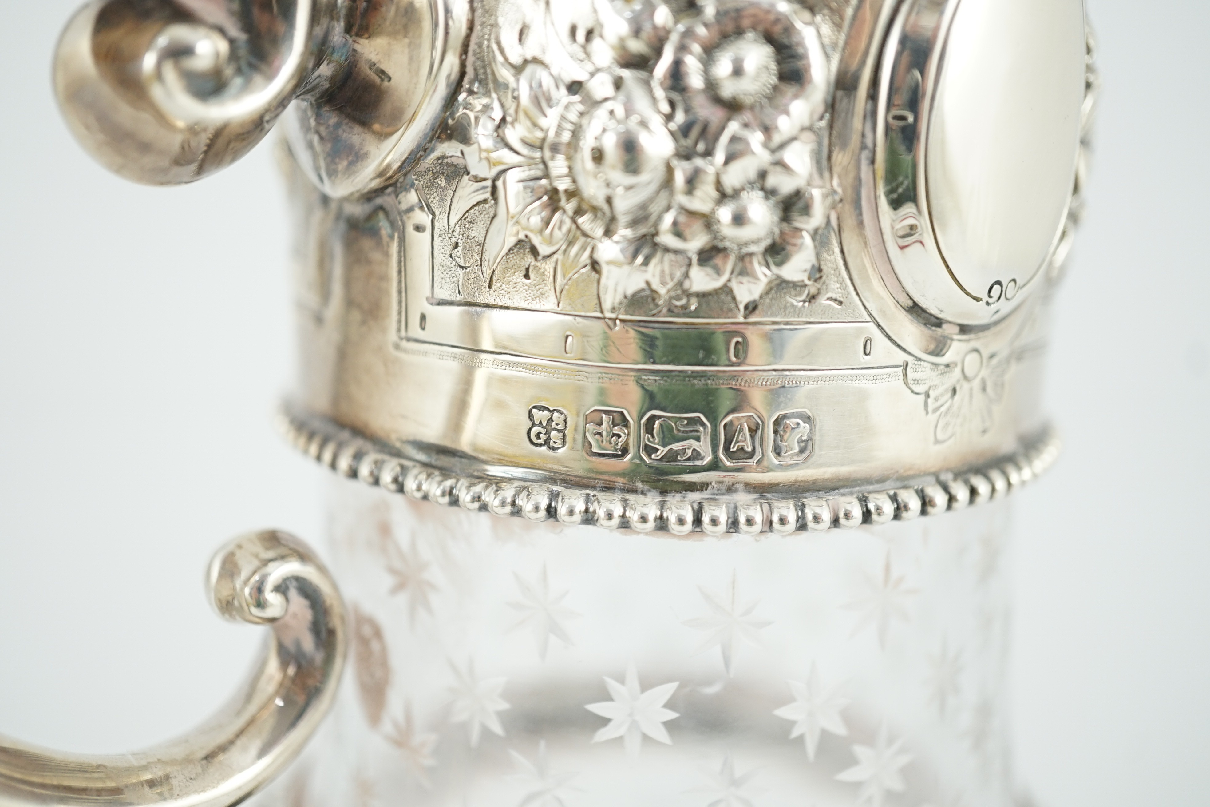 A Victorian embossed silver mounted engraved glass claret jug, the glass later, the silver, Sheffield, 1868, by William and George Sissons